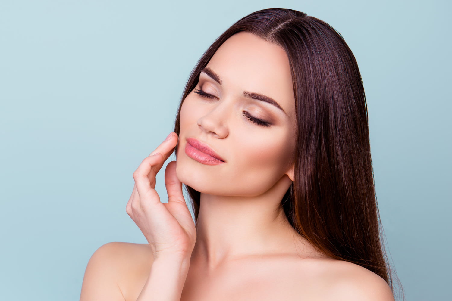 Woman touching her smooth skin after Daxxify injections