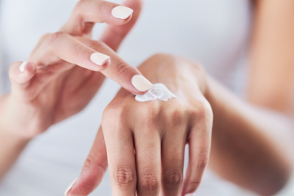 Woman applying hand cream