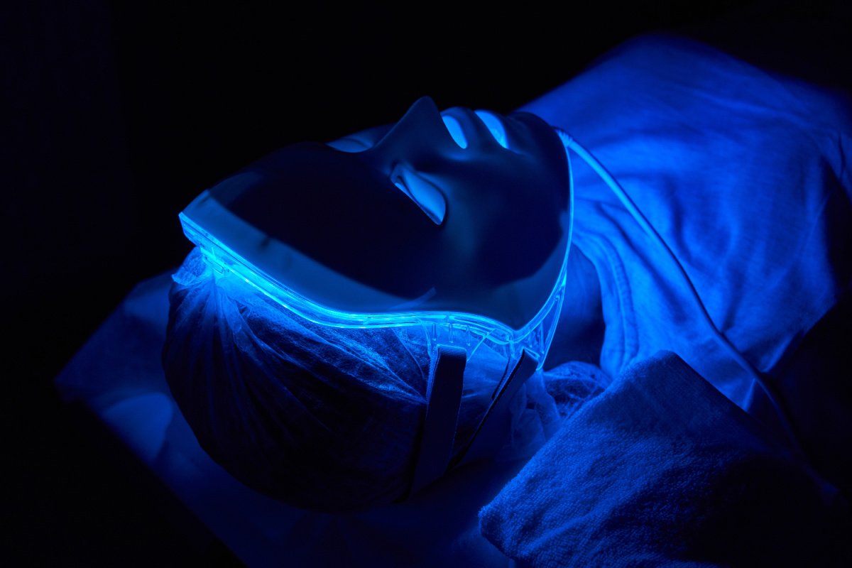 Woman using LED mask for beauty and skin benefits